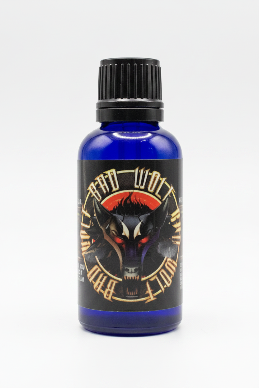 A cobalt blue glass bottle with a black ribbed cap and a black label featuring a stylized wolf head illustration and the text 'Black Wolf' and 'Bite'.
