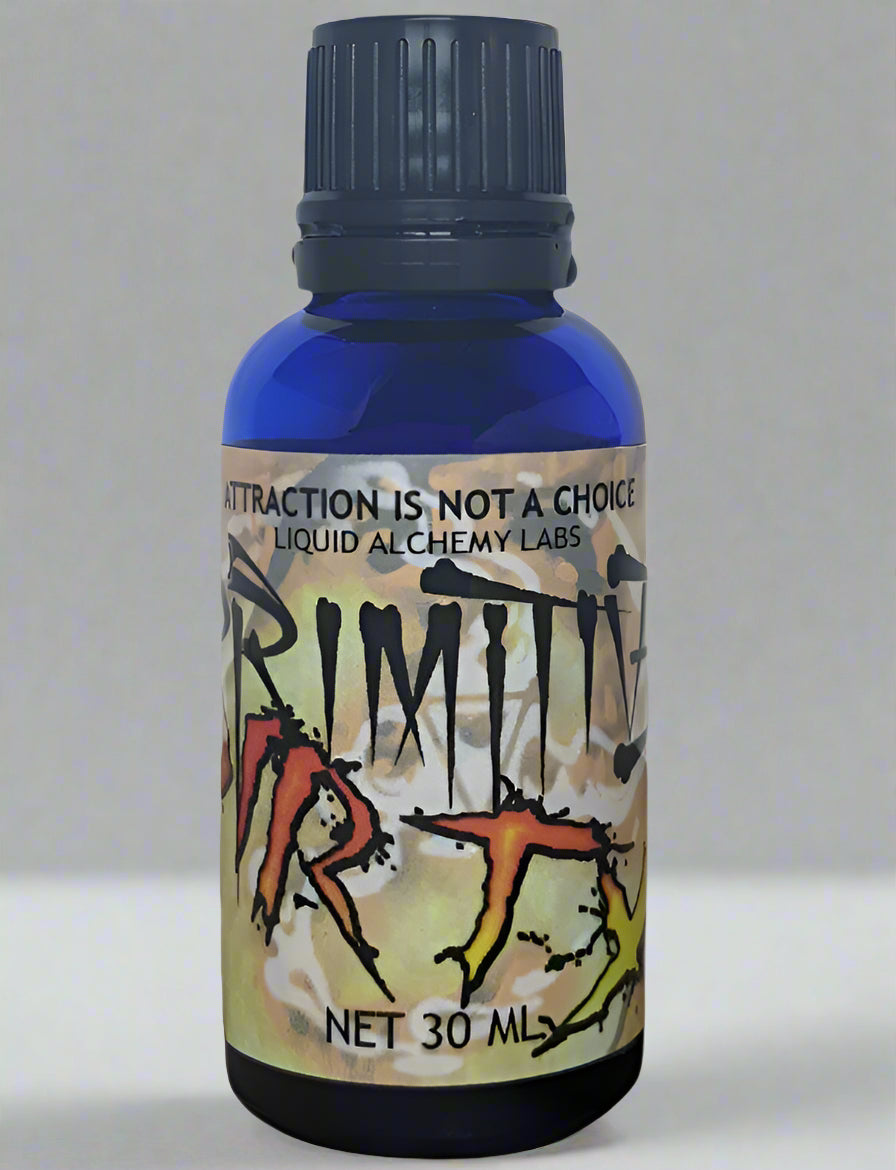 A 30ml blue bottle labeled "PRIMITIVE DIRTY" with a rugged design and "Attraction is Not a Choice" by Liquid Alchemy Labs.