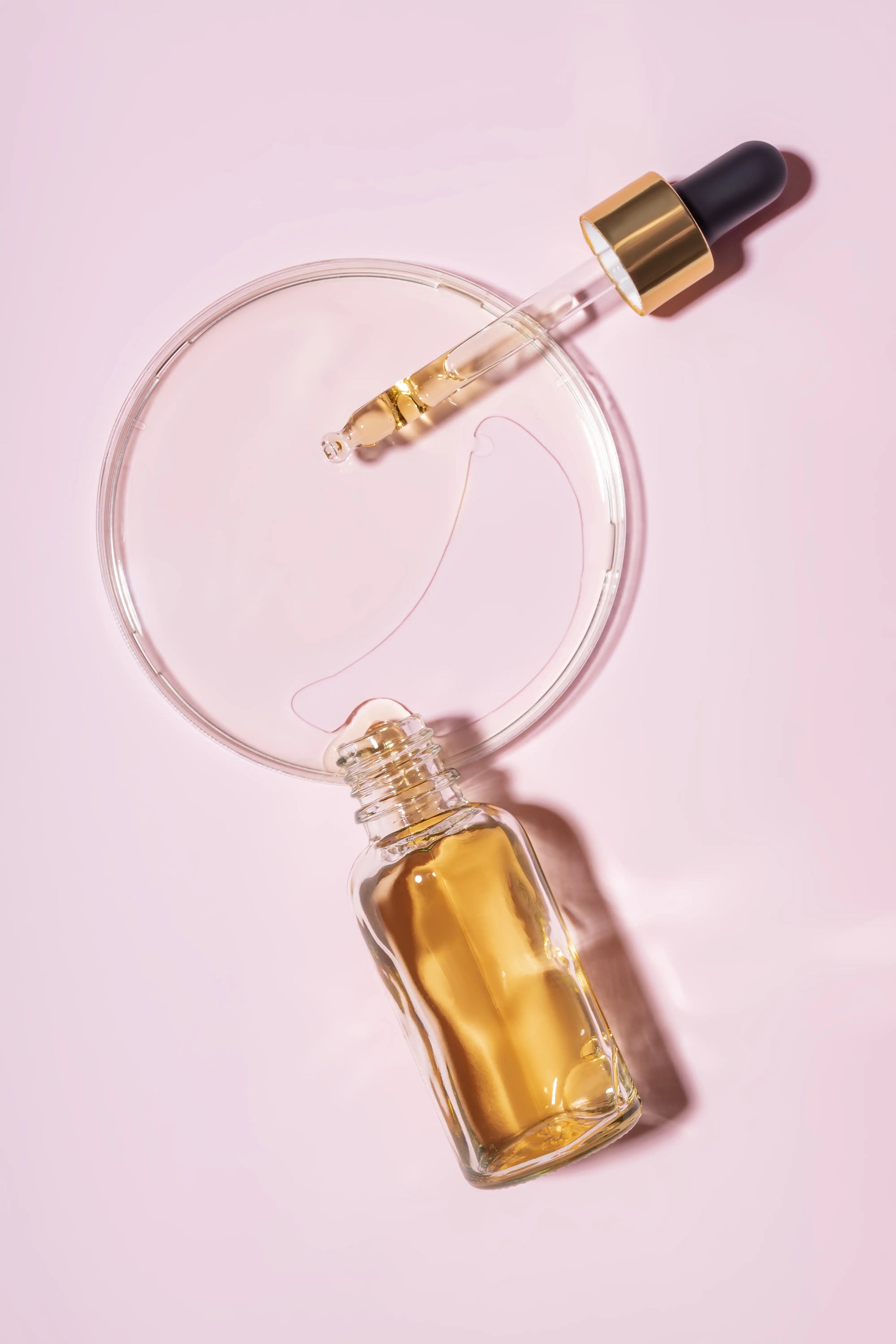 dropper-bottle-and-petri-dish-with-drops-of-pheromone-oil