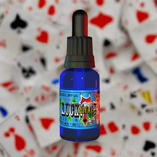 Blue glass dropper bottle labeled 'Lucky 7 Royal' featuring colorful artwork and black dropper cap with cards in the background.